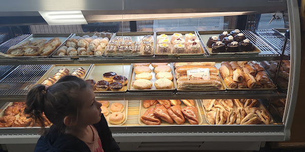 A wide bakery counter with assorted pastries and baked goods