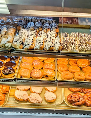 Rows of colourful pastries in the bakery display case